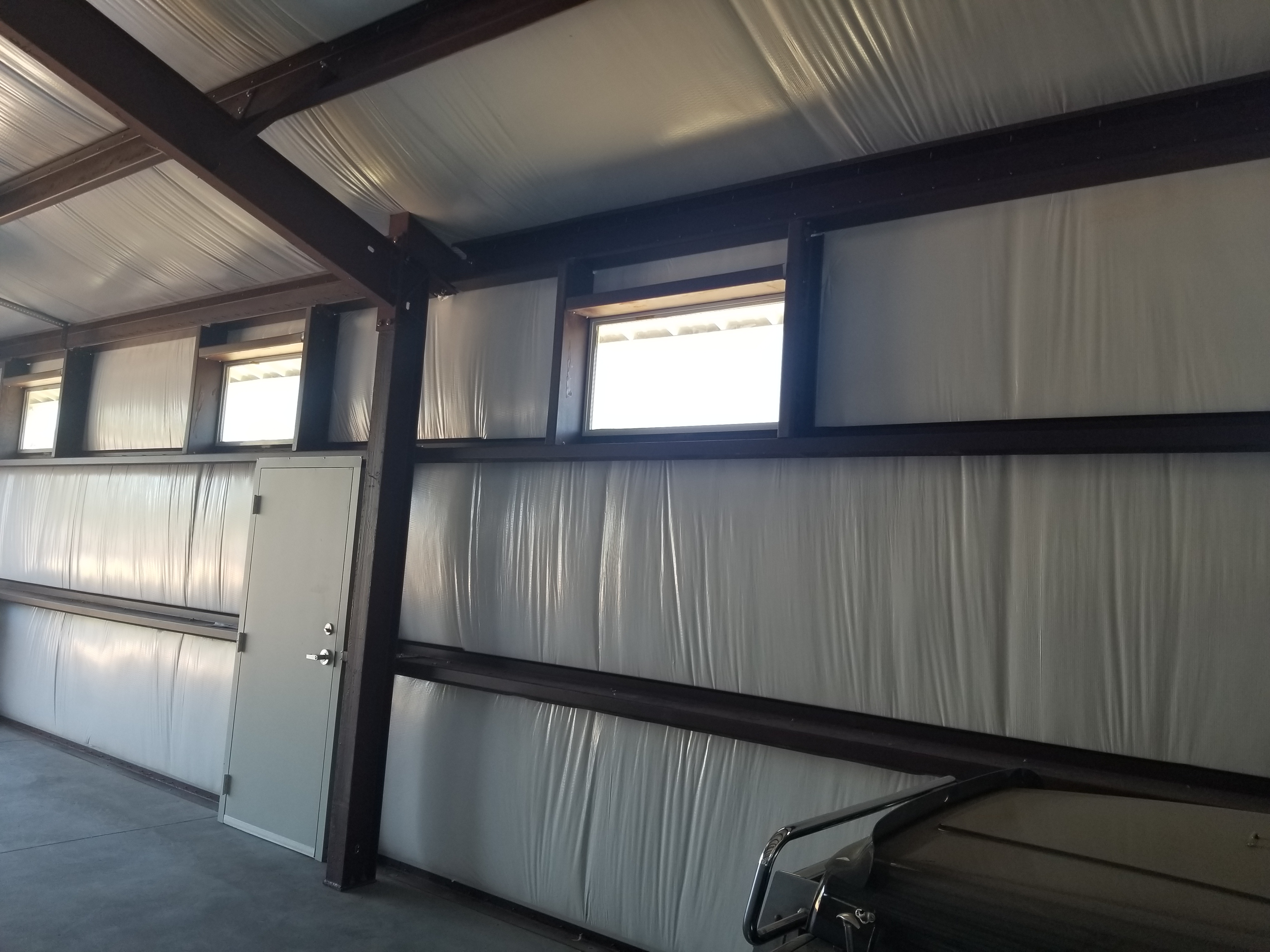 Showing high windows as seen from the interior of a steel building. Emphasizing the look and natural lighiting high windows provide