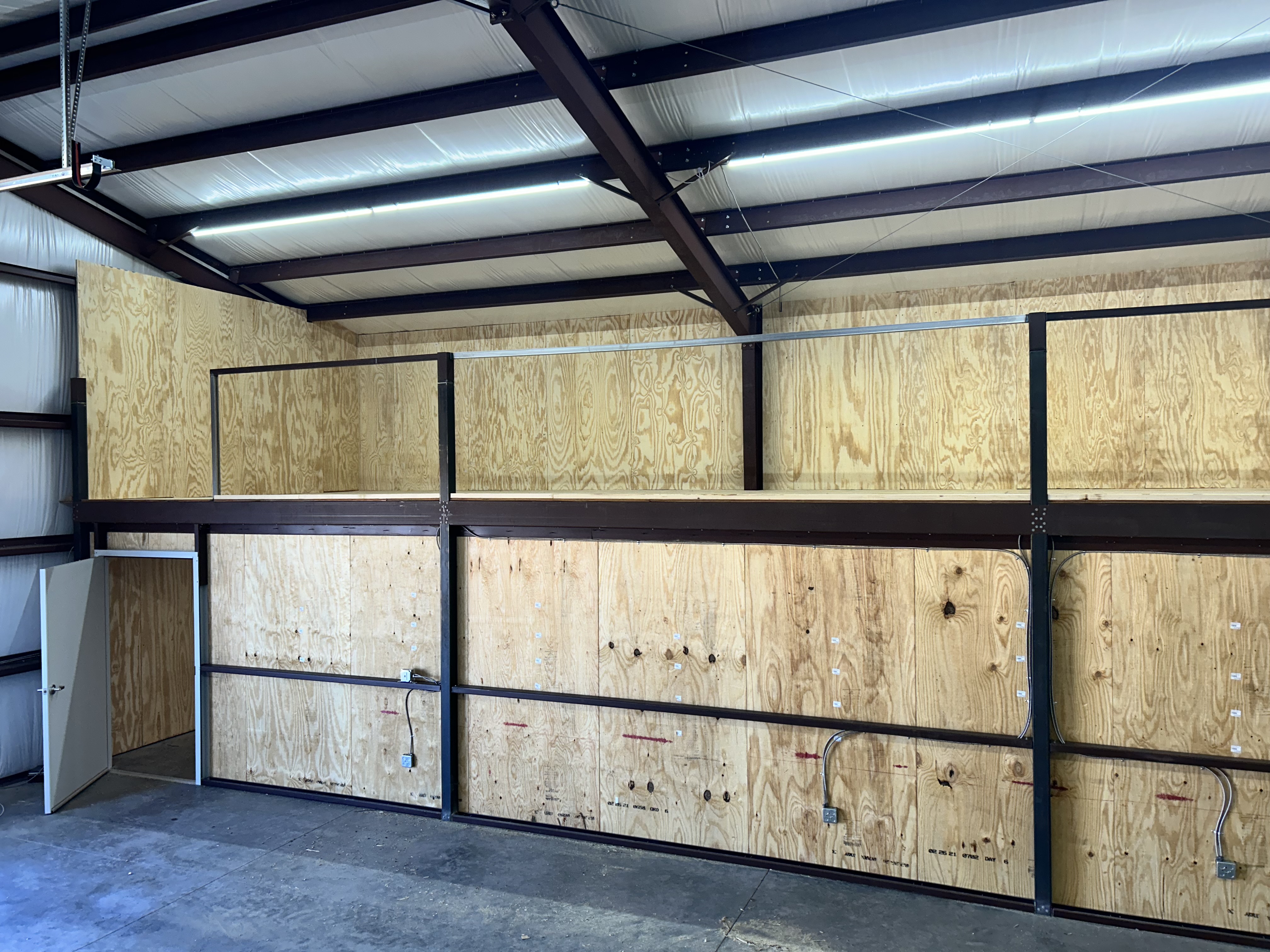 Showing a mezzanine sheeted in plywood. Emphasizing the durability of interior plywood sheeting